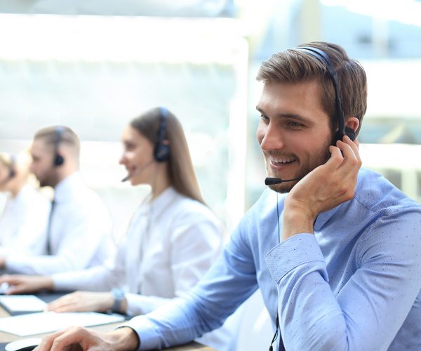 f2f – Grandstream GRP2615 main image An employee using a headset to speak to a client.